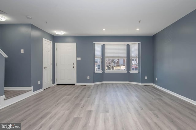 interior space featuring recessed lighting, wood finished floors, and baseboards