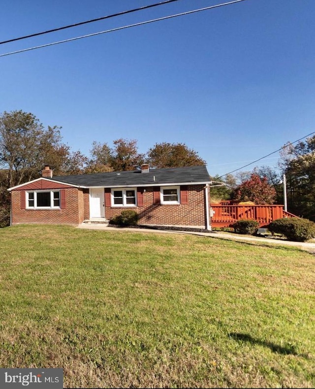 single story home featuring a front lawn, a chimney, and brick siding