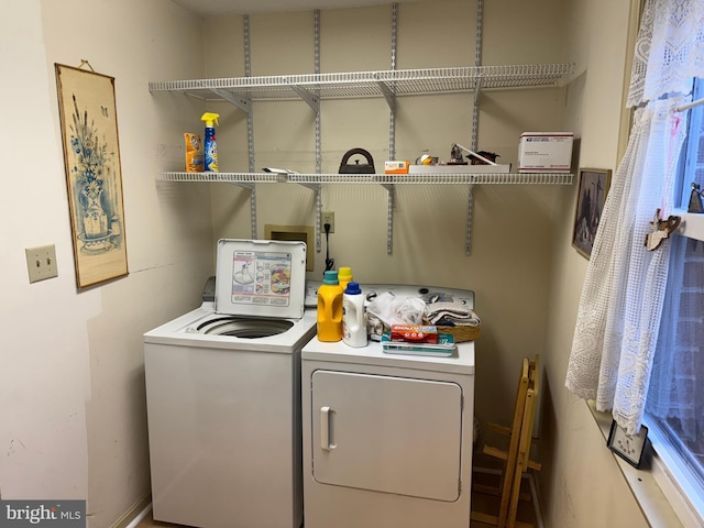 clothes washing area with laundry area and separate washer and dryer