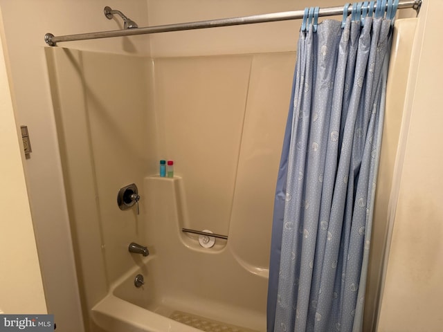 bathroom featuring shower / tub combo with curtain