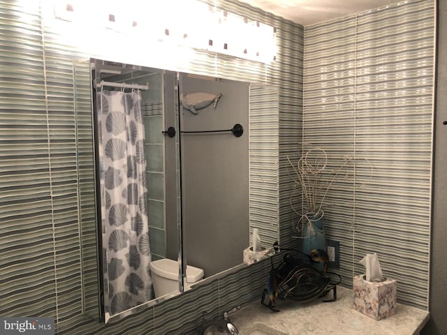 bathroom featuring curtained shower and toilet