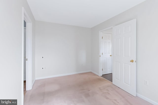 unfurnished bedroom with carpet floors and baseboards