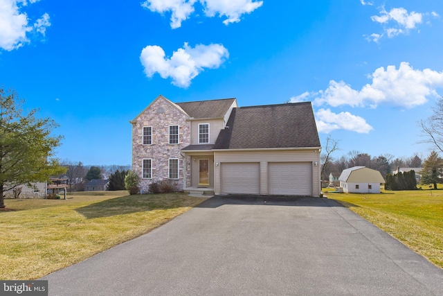 traditional home with a garage, stone siding, a front lawn, and driveway