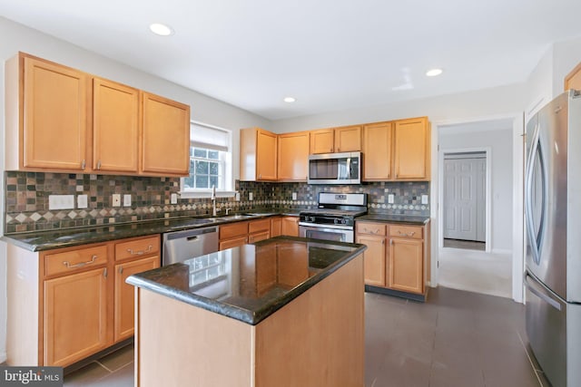 kitchen with a sink, stainless steel appliances, and light brown cabinets