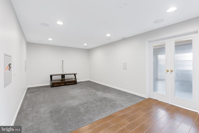 unfurnished room featuring recessed lighting, french doors, baseboards, and wood finished floors