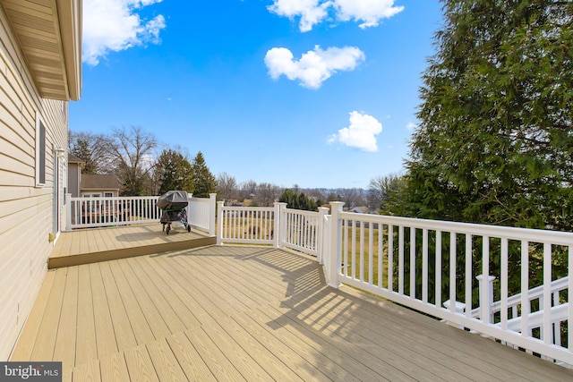 wooden terrace featuring area for grilling