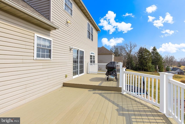 wooden deck featuring area for grilling