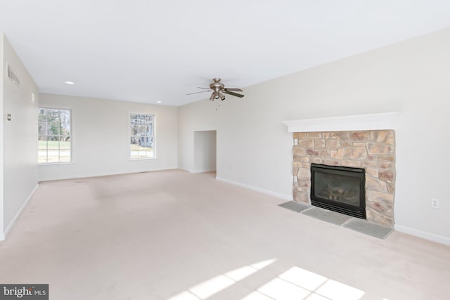 unfurnished living room featuring carpet floors, a fireplace, visible vents, ceiling fan, and baseboards