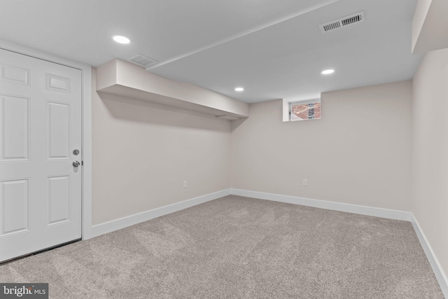 below grade area with carpet, visible vents, baseboards, and recessed lighting