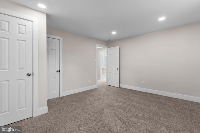 unfurnished bedroom featuring recessed lighting, carpet flooring, and baseboards