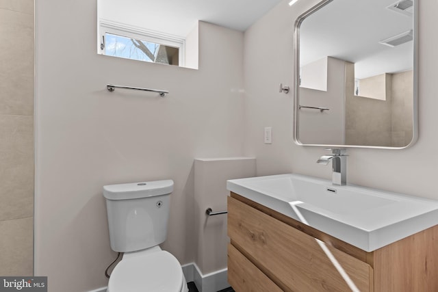 bathroom featuring visible vents, vanity, and toilet