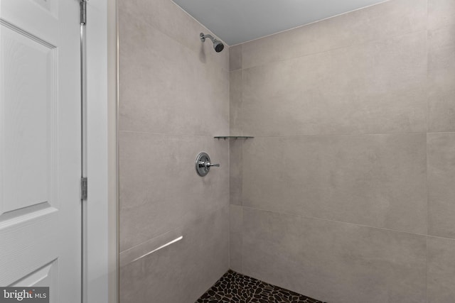 bathroom with a tile shower