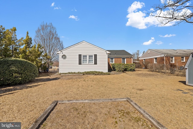 back of house featuring brick siding