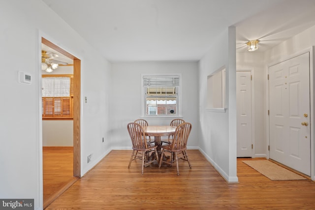 dining area with light wood-style floors, visible vents, and baseboards