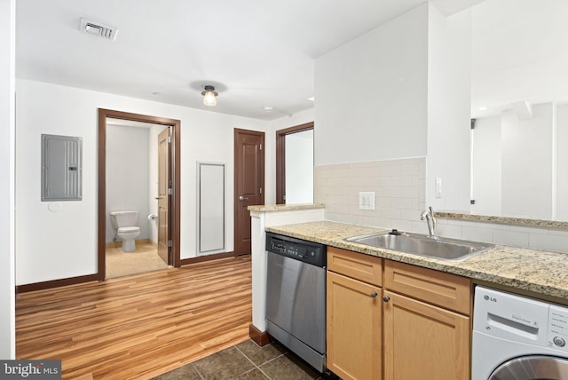 kitchen with electric panel, washer / clothes dryer, backsplash, stainless steel dishwasher, and a sink