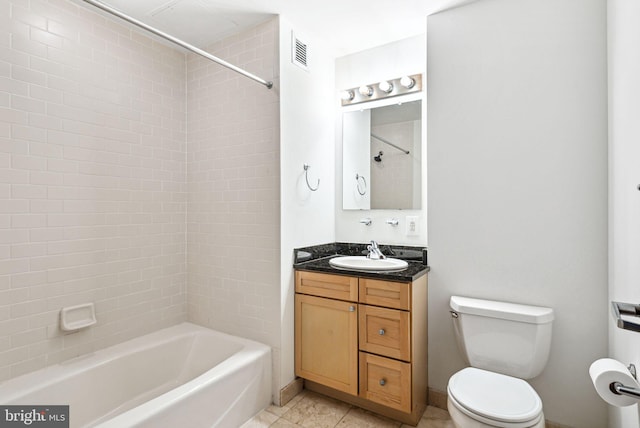 full bathroom featuring toilet, visible vents, vanity, tile patterned floors, and washtub / shower combination