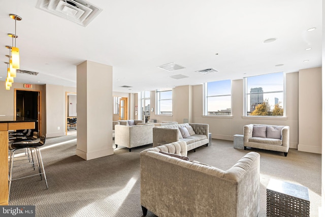 living room featuring baseboards, visible vents, and carpet flooring