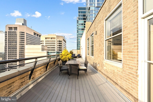 wooden terrace featuring a view of city