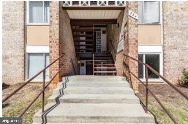 view of exterior entry featuring brick siding