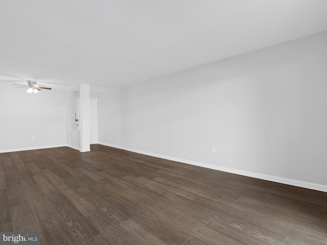 unfurnished living room with dark wood finished floors, a ceiling fan, and baseboards