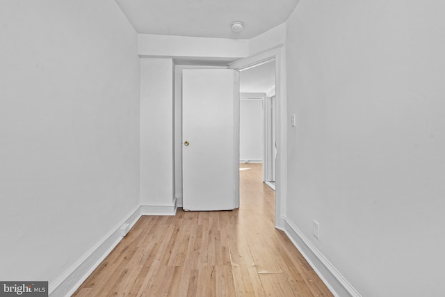 interior space featuring light wood finished floors and baseboards