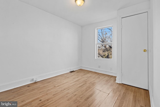 unfurnished bedroom featuring light wood finished floors and baseboards