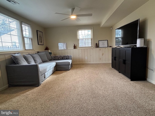 living room featuring light colored carpet, plenty of natural light, visible vents, and ceiling fan