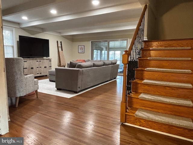 living area with stairs, wood finished floors, beam ceiling, and recessed lighting