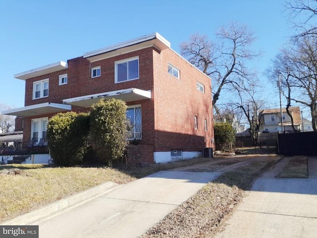 view of side of property featuring brick siding