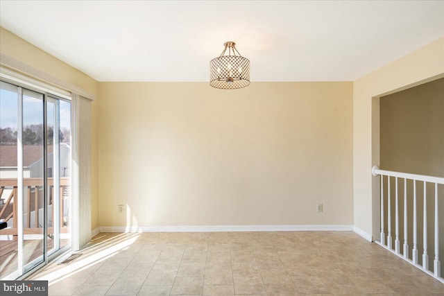 empty room with light tile patterned flooring and baseboards