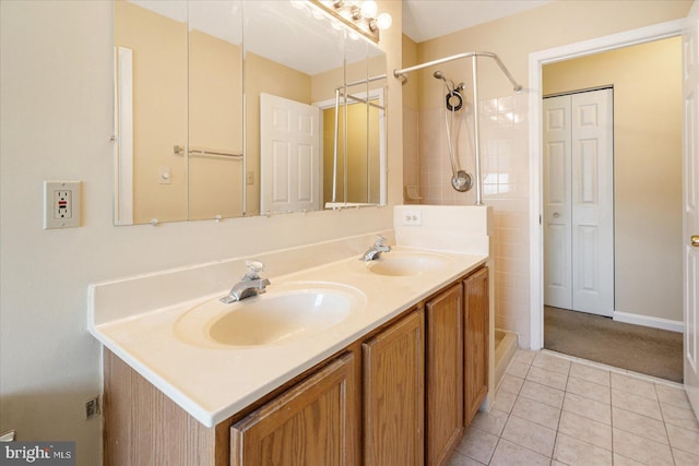 bathroom featuring double vanity, a closet, tile patterned flooring, and a sink