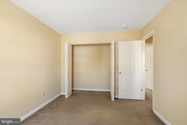 unfurnished bedroom with a closet and baseboards