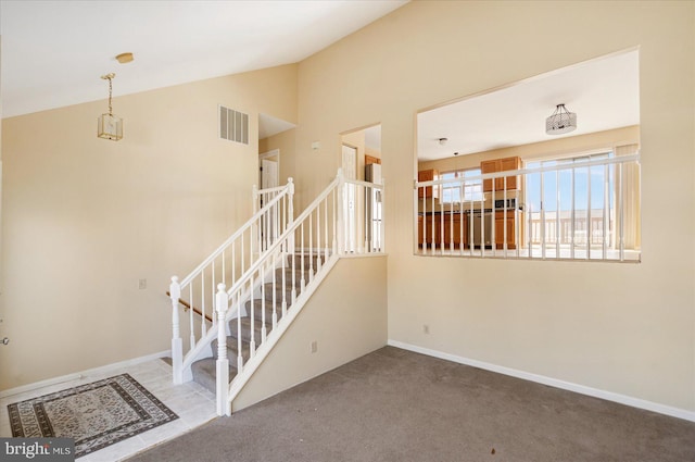 stairs with carpet floors, visible vents, and baseboards