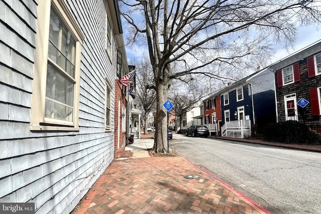 view of street with curbs, traffic signs, and sidewalks