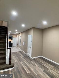 interior space featuring recessed lighting, dark wood finished floors, stairway, and baseboards