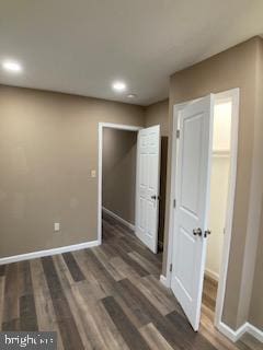 interior space with dark wood-style floors and baseboards