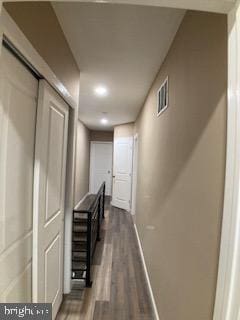 corridor with visible vents, dark wood finished floors, and baseboards