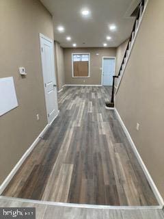 hallway featuring recessed lighting, stairway, baseboards, and wood finished floors