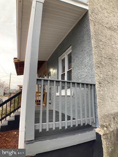 view of side of property with stairway and stucco siding