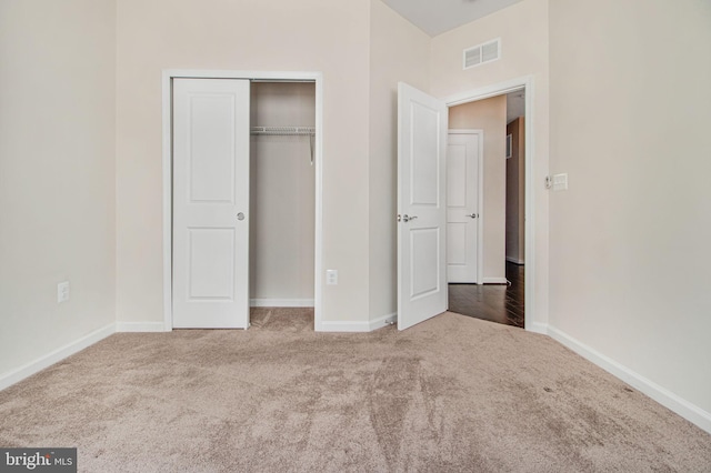 unfurnished bedroom with baseboards, visible vents, and carpet flooring