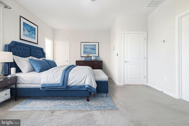 bedroom with carpet flooring, visible vents, and baseboards