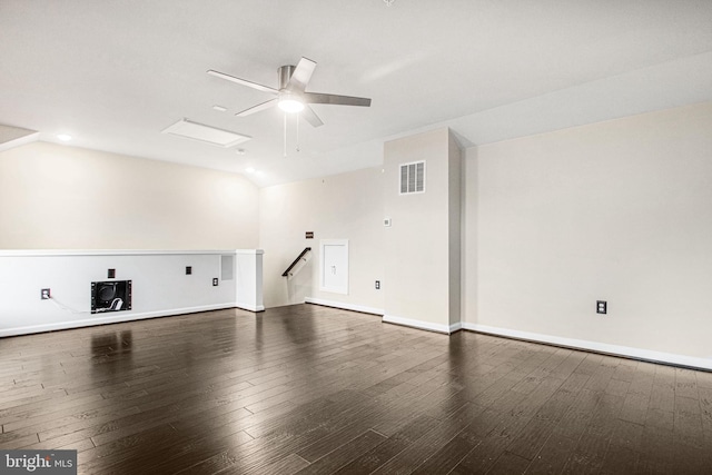 interior space with lofted ceiling, visible vents, ceiling fan, wood finished floors, and baseboards