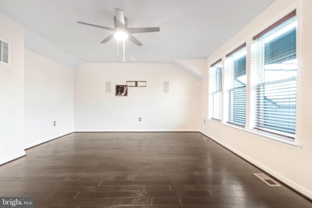 unfurnished room with dark wood-style floors, visible vents, ceiling fan, and baseboards