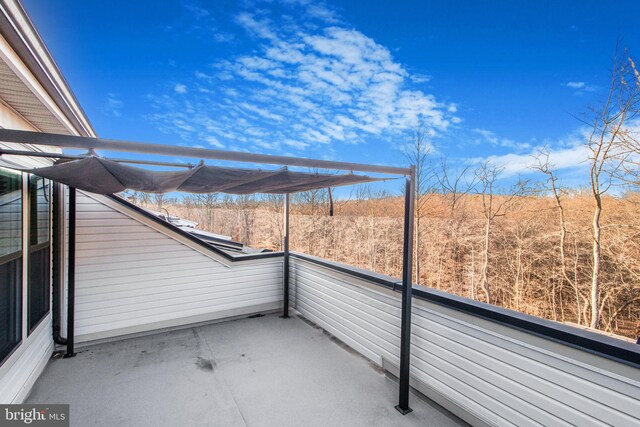 view of patio featuring a balcony