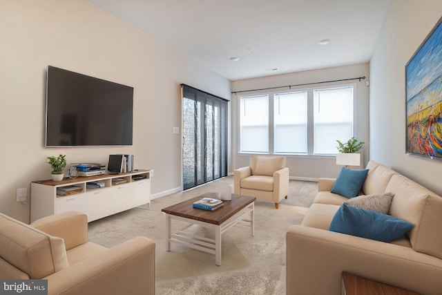 living room featuring light carpet and baseboards