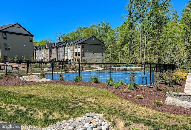 exterior space with a lawn and fence