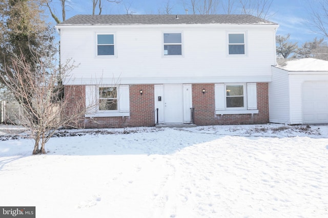 view of front of property featuring a garage and brick siding