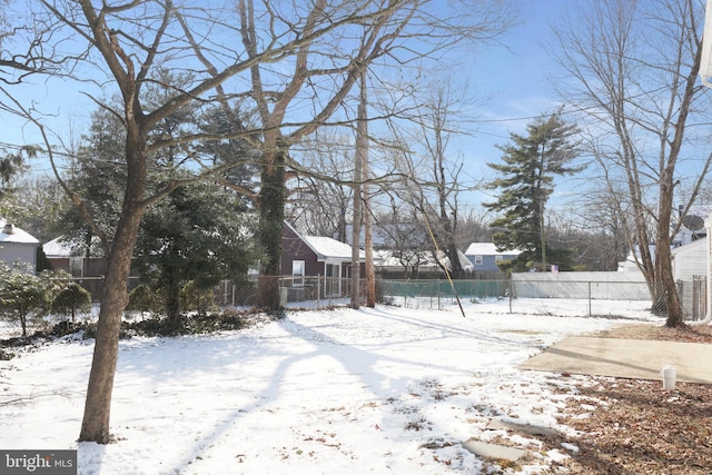 snowy yard with fence