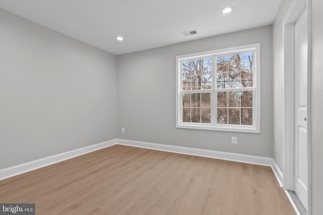 spare room featuring recessed lighting, visible vents, light wood finished floors, and baseboards