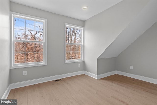 additional living space featuring light wood-style floors, recessed lighting, and baseboards